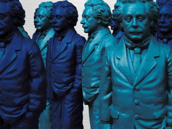 Einstein Figuren auf dem Ulmer Münsterplatz. Es zeigt das Bild von mehreren Skulpturen, die Albert Einstein darstellen sollen. Die Figuren sind in den Farben Dunkelblau und Türkis. Die Figuren sind stehend und tragen einen Herrenanzug. Die Figuren haben eine Hand ist in der Hosentasche und der andere Arm ist seitlich des Körpers.